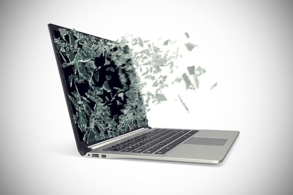 Modern metal laptop with broken screen isolated on white background.
