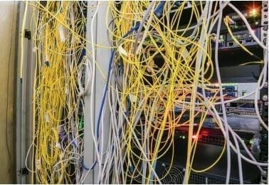 Tangled network cables in server room.