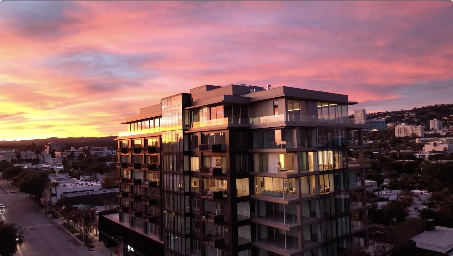 Modern building at sunset with vibrant sky.