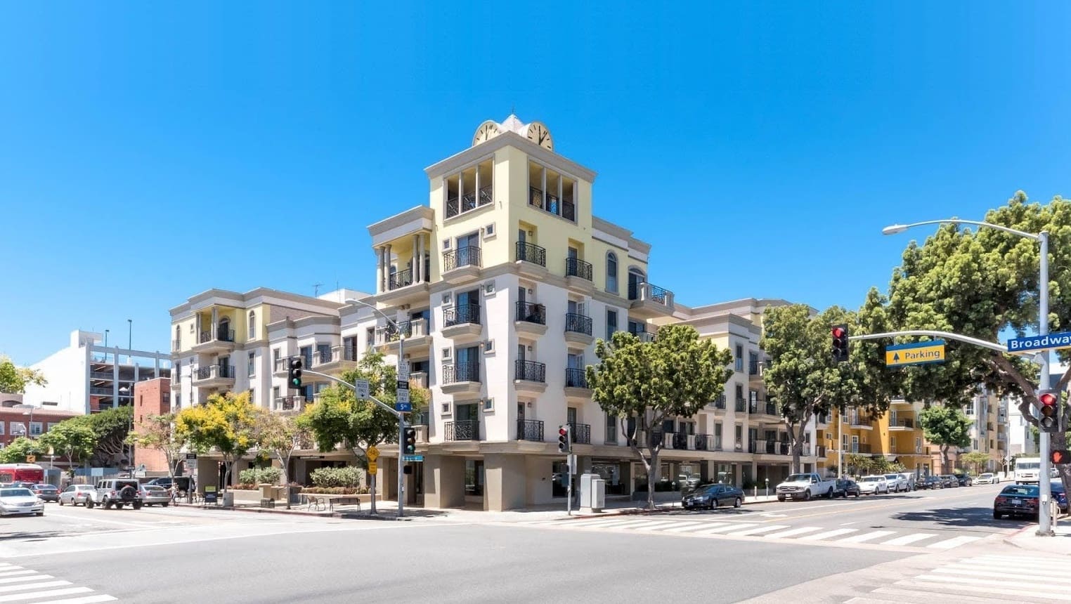 Corner building with trees and clear sky.
