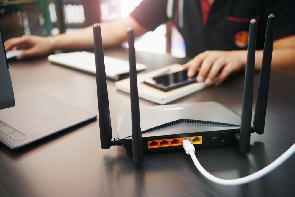 Wireless router on desk with connected devices.